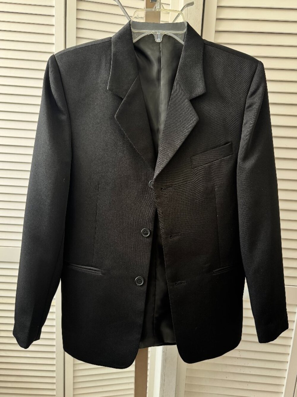Black blazer with a smooth satin lapel.